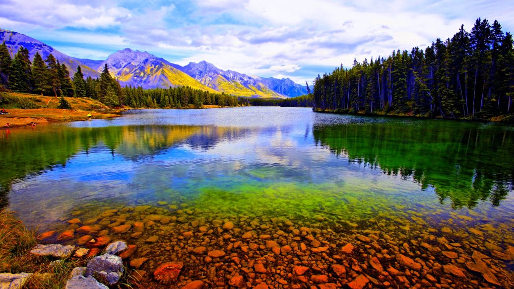 Reflection of mountains and trees in a lake, Lake Johnson, Banff National Park, Alberta, Canada --- Image by © George Oze Photography/SuperStock/Corbis